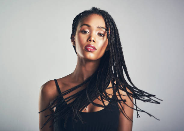 Go for the hairstyle Shot of a beautiful young woman posing against a grey background braids stock pictures, royalty-free photos & images