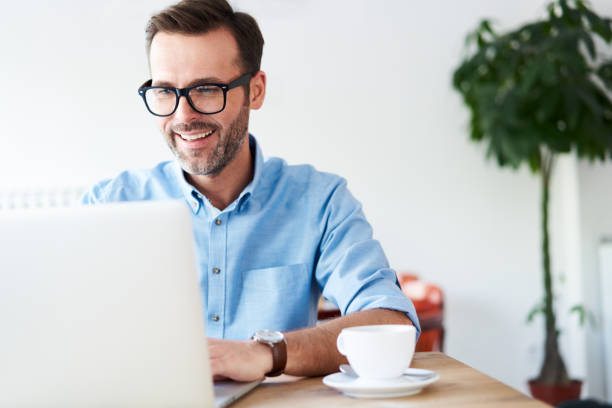 istock Handsome man at cafeteria, cafe working on laptop 1138353221