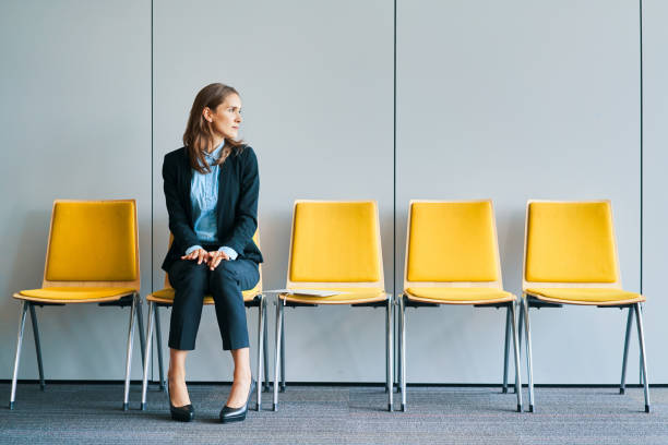 businesswoman waiting for job interview - sitting on a chair imagens e fotografias de stock