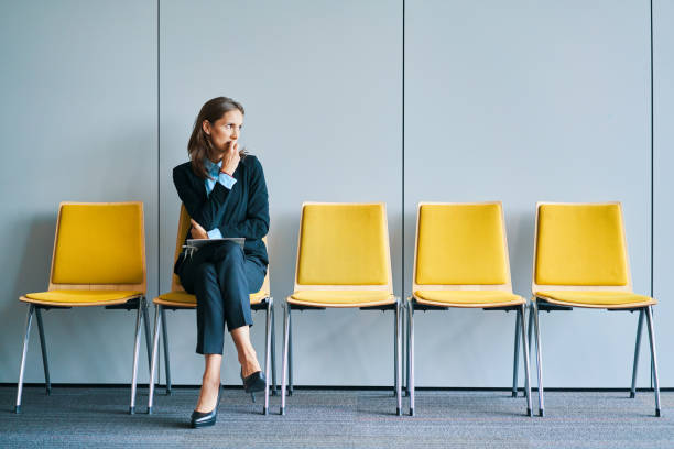 仕事の面接を待っているストレスの若い女性 - out of work ストックフォトと画像