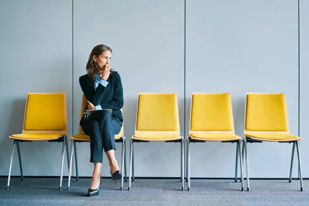 Photo of Stressful young woman waiting for job interview