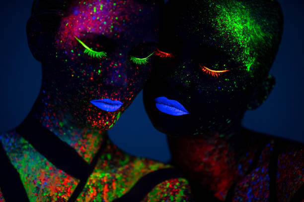 istock Two young women painted with fluorescent colors 1138355358