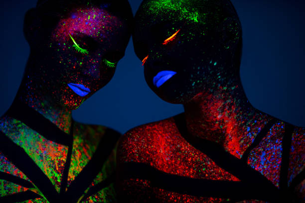 istock Two young women painted with fluorescent colors 1138355385