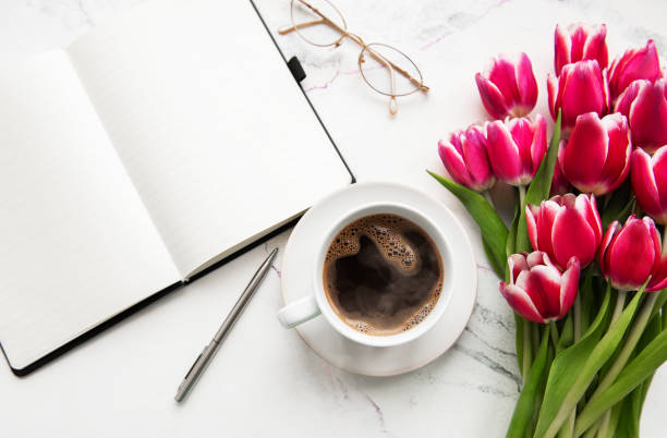istock Notebook, cup of coffee  and pink tulips 1138358249
