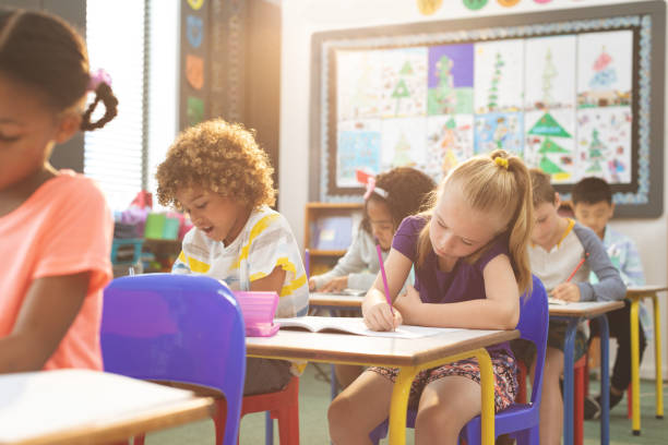 istock School kids writting on notebook in classroom at school 1138358618