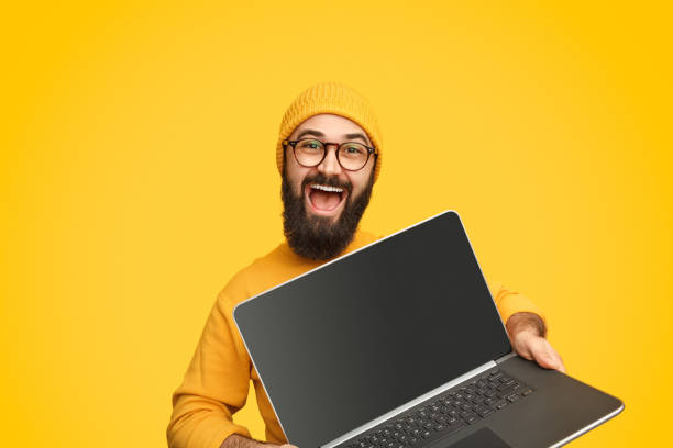 istock Smiling man promoting modern laptop 1138358766