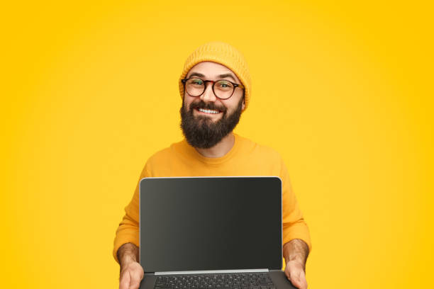 istock Smiling male showing laptop 1138358770