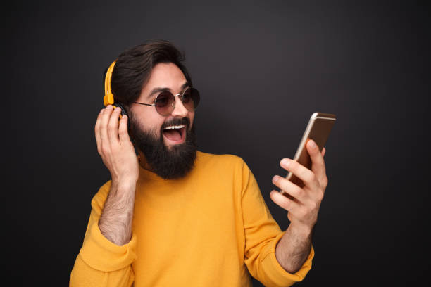 istock Man with smartphone listening to music 1138358773