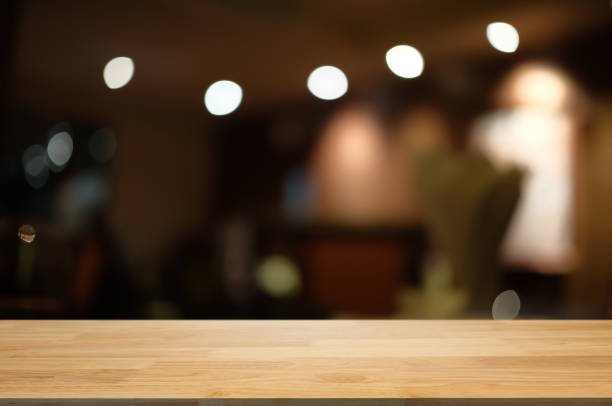 istock empty wood table with blur montage restaurant background. 1138360358