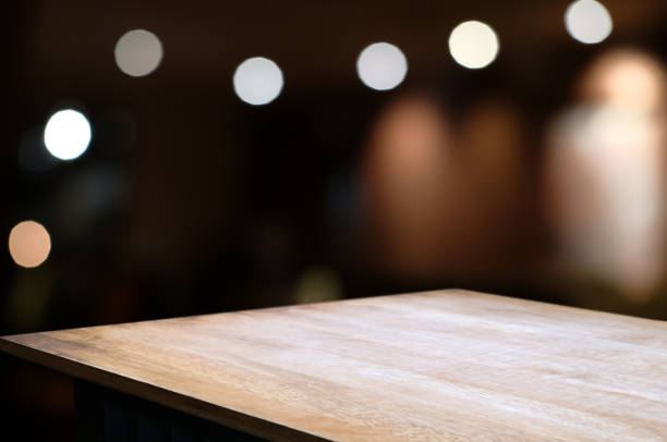 istock empty wood table with blur montage restaurant background. 1138360360