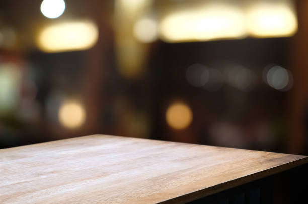 istock empty wood table with blur montage restaurant background. 1138360374
