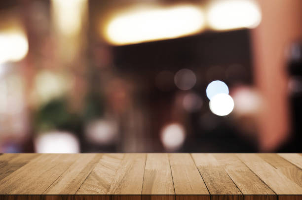 istock empty wood table with blur montage restaurant background. 1138360380