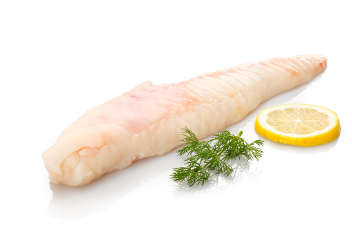 Monkfish filet raw with dill and lemon white isolated