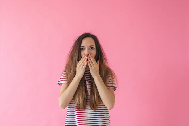 istock Girl covers her mouth 1138361099