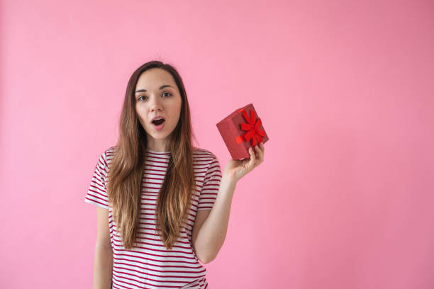 istock The girl holds a gift in hand 1138361313