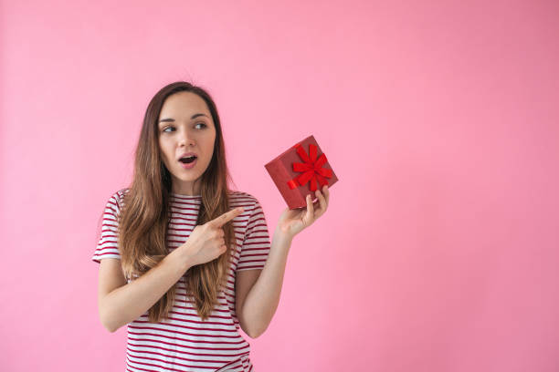 istock The girl holds a gift in hand 1138361325