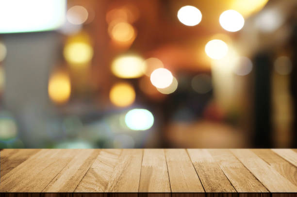 istock empty wood table top over blur night light in restaurant cafe background. 1138362180