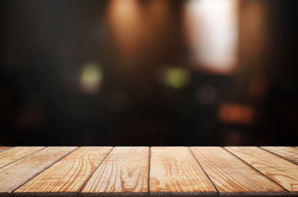 istock empty wood table top over blur night light in restaurant cafe background. 1138362181