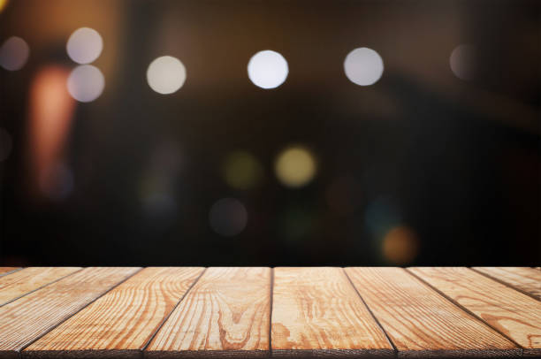 istock empty wood table top over blur night light in restaurant cafe background. 1138362186