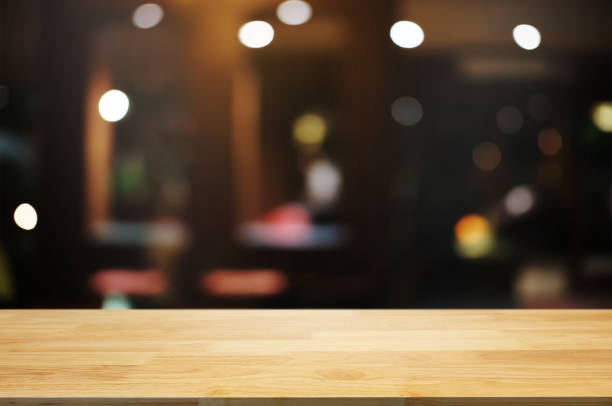 istock empty wood table top over blur night light in restaurant cafe background. 1138362199