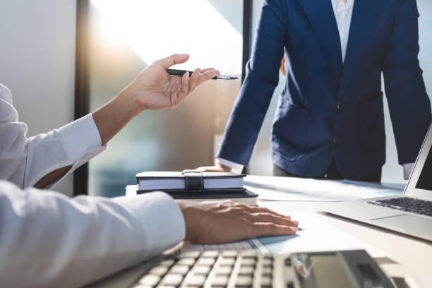 istock business administrator negotiation discussing  about investment data spreadsheets in modern office. 1138362229