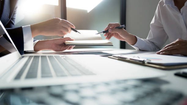 business administrator negotiation discussing  about investment data spreadsheets in modern office.