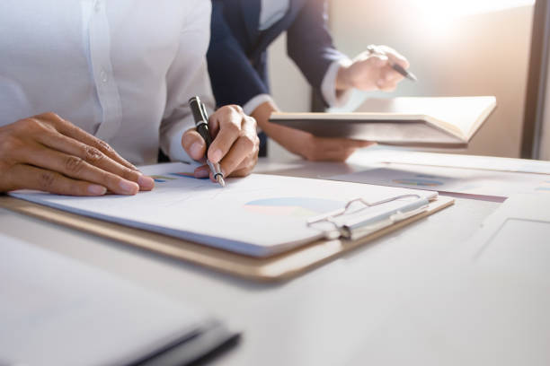 istock business administrator negotiation discussing  about investment data spreadsheets in modern office. 1138362238