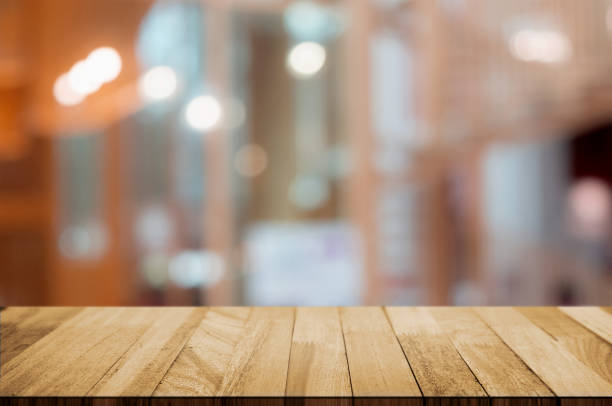 istock empty wood table top over blur in restaurant cafe background. 1138362243