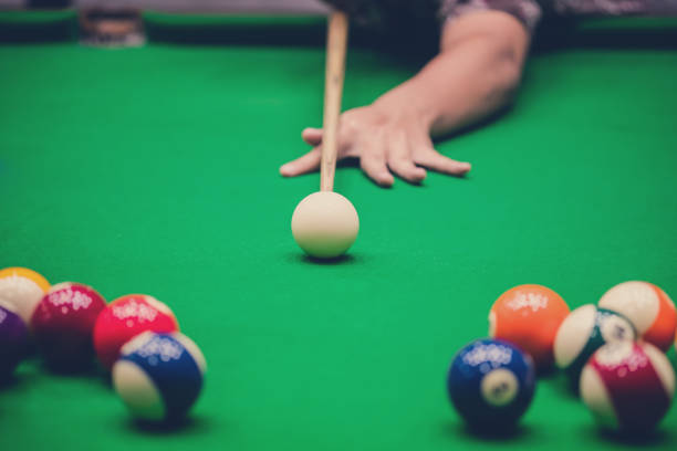 istock Male hand playing Snooker or Pool game on green table. 1138362282