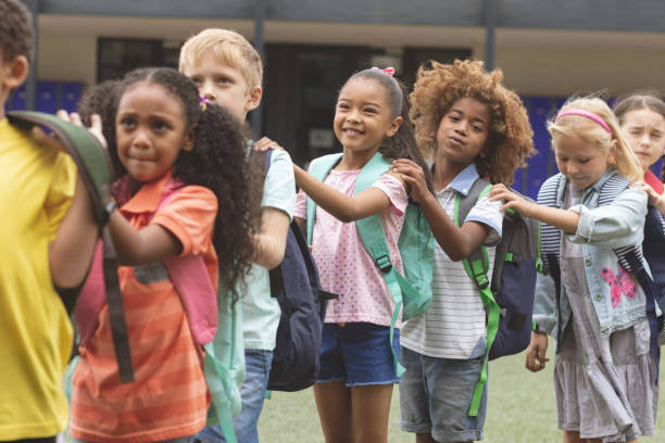 istock School kids standind in a queue at schoolyard 1138362396
