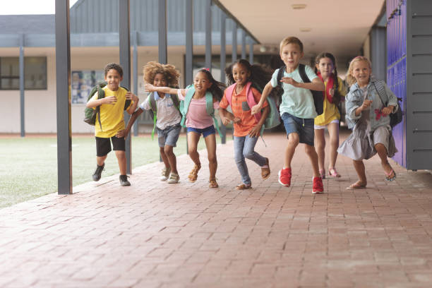 istock Happy school kids running in corridor 1138362403