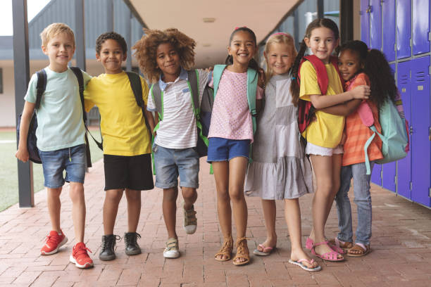 istock Happy school kids standing in corridor 1138362422