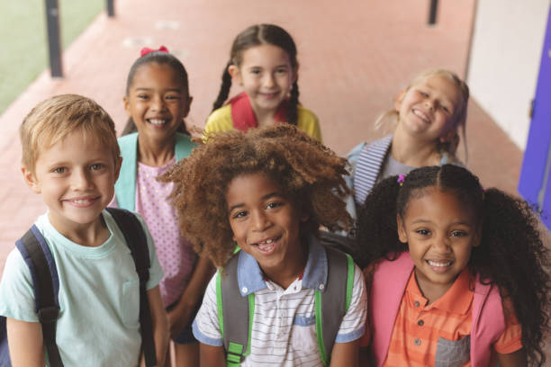 istock Happy school kids standing in corridor 1138362462