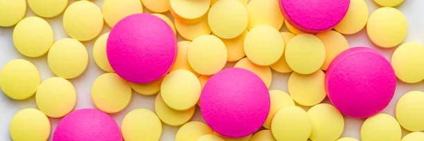 istock Yellow and pink pills on a white background. 1138362503