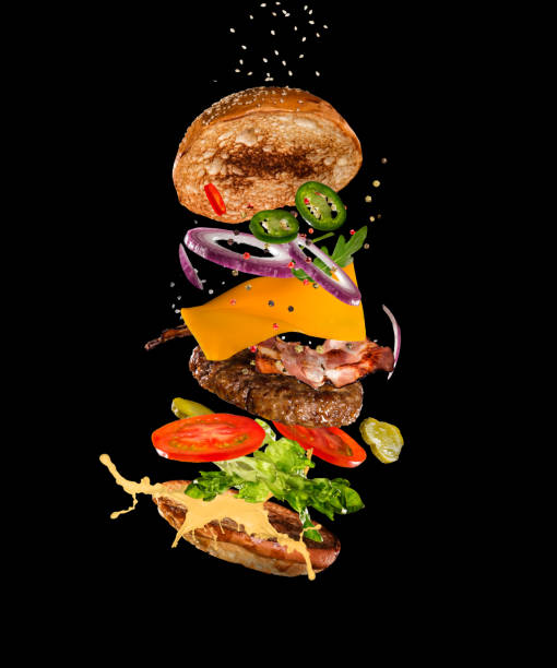istock Tasty hamburger with flying ingredients on dark background 1138363546