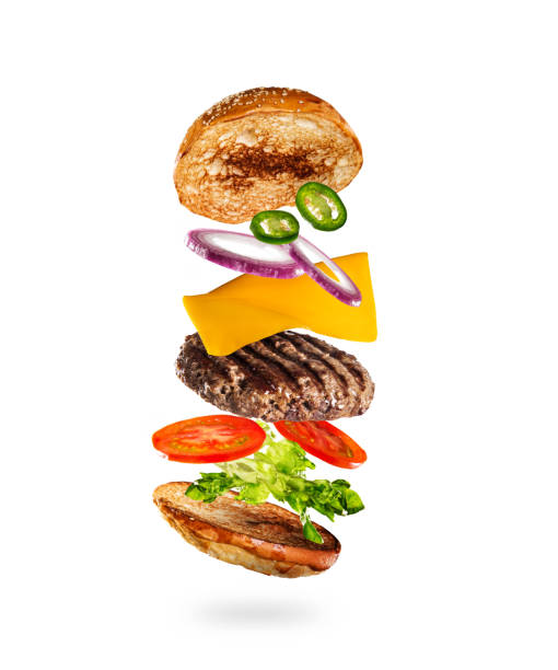 istock Tasty hamburger with flying ingredients on white background 1138363566
