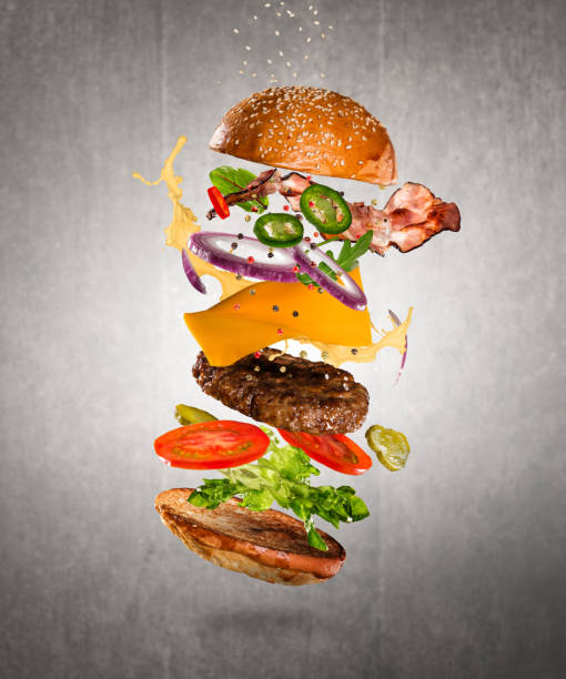 istock Tasty cheeseburger with flying ingredients on dark background 1138363616