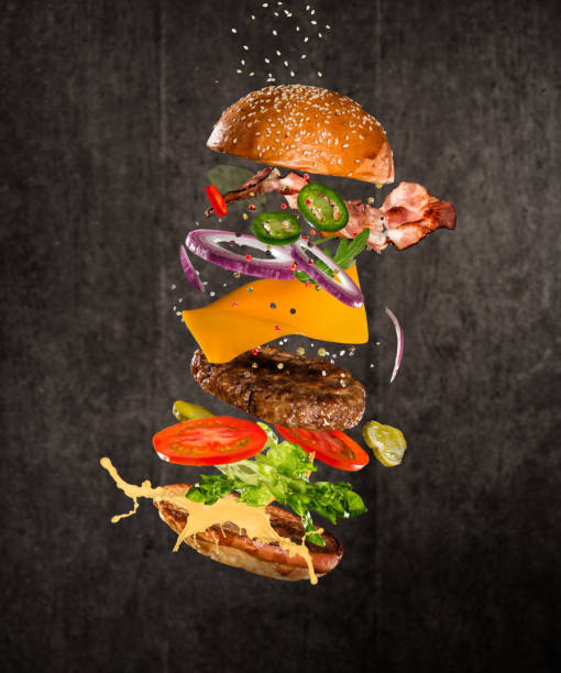 istock Tasty cheeseburger with flying ingredients on dark background 1138363627