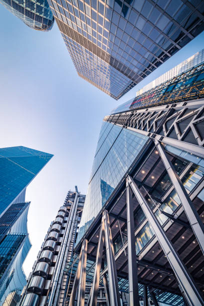 istock Night low angle view upwards in London's financial district - toned stock image 1138363753