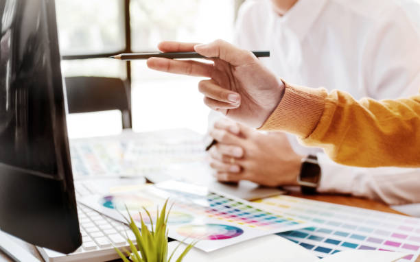 istock Interior or Graphic designer meeting discussing about color chart in studio. 1138364195