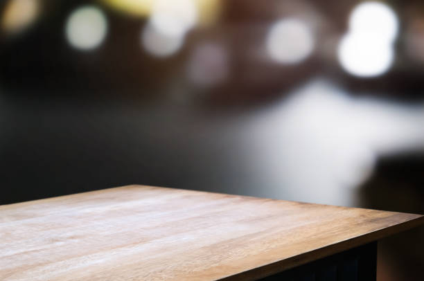 istock empty wood table top over blur night light in restaurant cafe background. 1138364260