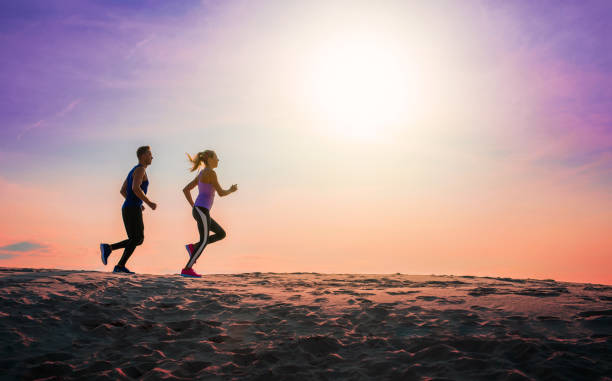 istock Silhouette of people jogging at sunset 1138364656
