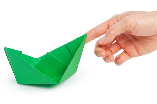 istock Paper ship in a female hand 1138364659