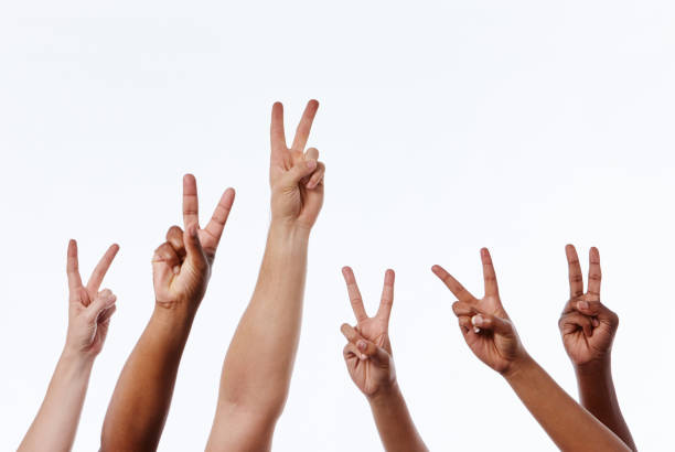 istock Six raised hands make V signs for peace or victory 1138365663