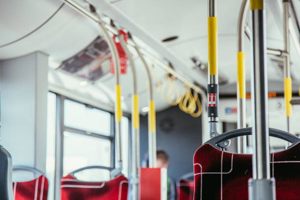 istock Interior of a public transport bus and stop Button in a bus, blurry background 1138366920