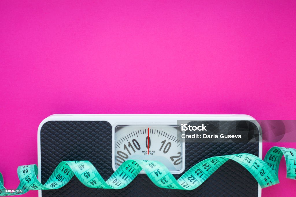 Diet & Weight control Fruits, measuring tape and weighing-machine on the pink background.
Weight loss, diet control and healthy food concept background. Dieting Stock Photo