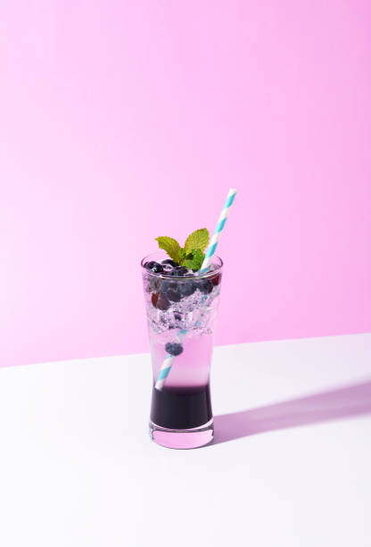 istock Cold and refreshing  blueberry punch cocktail with mint on purple background. summer drink 1138368884