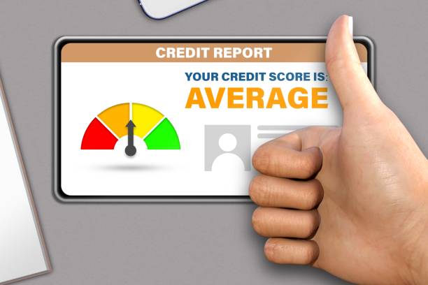 istock hand with smart phone shows thumb up or like gesture   on modern table background - average credit score technology concept 1138370069