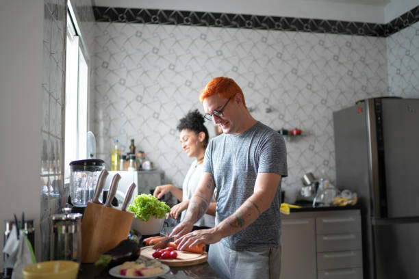 istock Couple cooking together at home 1138370473