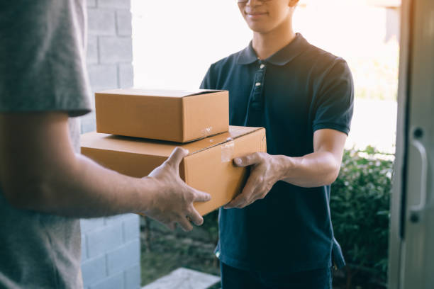 istock Smart courier making a delivery to a customer at home. 1138370882